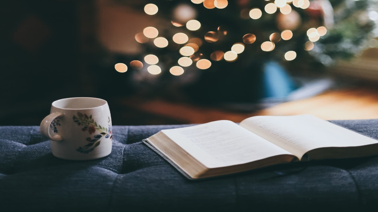 A mug and an open book