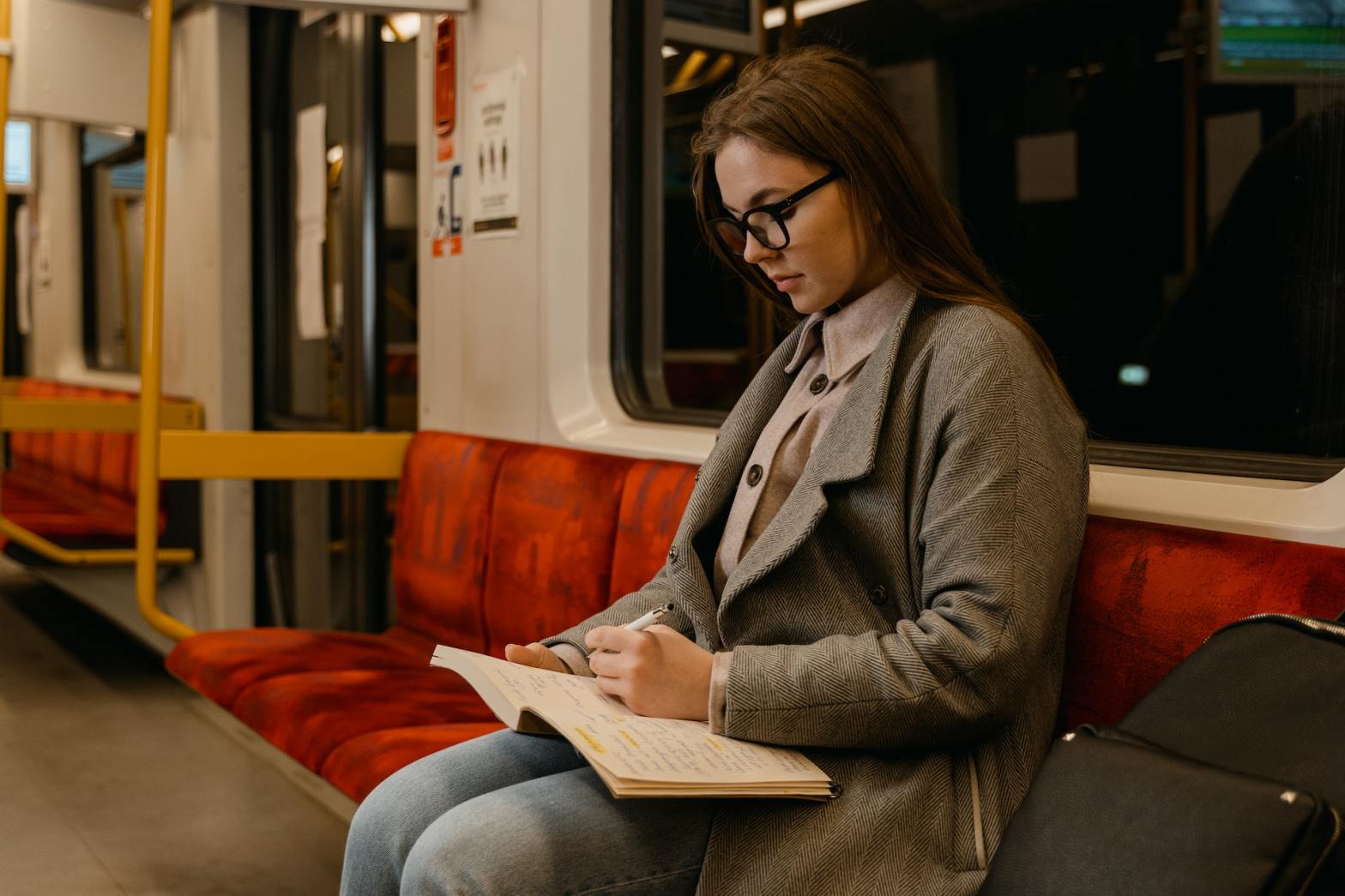 woman writing in train link between poetry and traveling